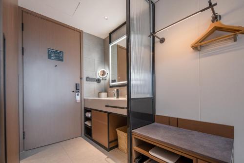 a bathroom with a sink and a shower at Spring Hotel Shenzhen Bao'an International Airport in Shenzhen