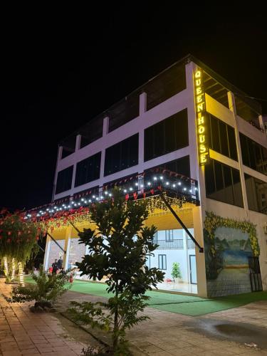 a large building with lights on it at night at Queen House in Hoàng Ngà