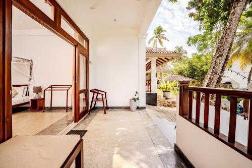 an open balcony with a view of a house at Serenity Boutique - Unawatuna in Unawatuna