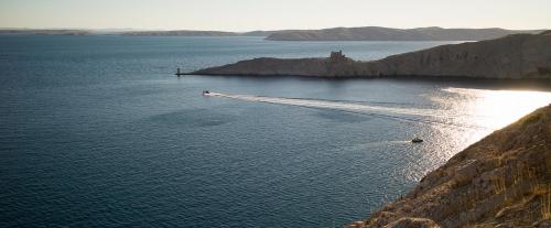 a large body of water with a boat in it at House Natali 70m from the beach - free EV top up in Rtina