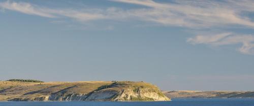 a large rock in the middle of a body of water at House Natali 70m from the beach - free EV top up in Rtina