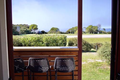 two chairs sitting in front of a window at BIG4 Wilsons Prom Holiday Park in Yanakie