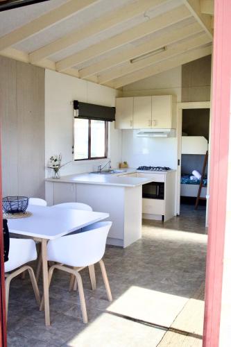 a kitchen and dining room with a table and chairs at BIG4 Wilsons Prom Holiday Park in Yanakie