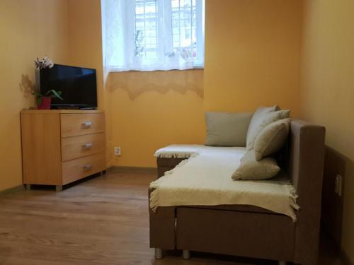 a bedroom with a bed and a tv and a dresser at Pokoje Gościnne Centrum in Krakow