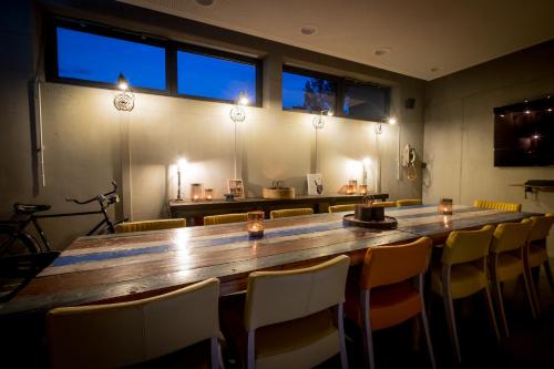 a large wooden table in a room with chairs at Hotel FREIgeist Einbeck BW Signature Collection in Einbeck