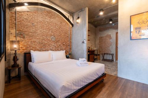 Ένα ή περισσότερα κρεβάτια σε δωμάτιο στο House of Machine Boutique Hotel