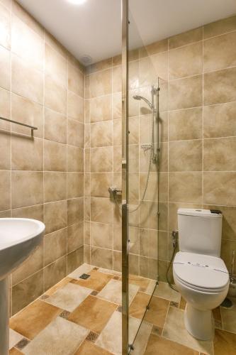 a bathroom with a shower and a toilet and a sink at Robinson Hotel in Zatoka
