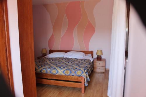a bedroom with a bed in a room with a wall at B&B Dal Pescatore in Fažana