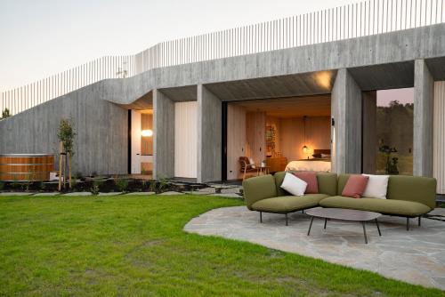 a house with two couches on a patio at Craggy Range Luxury Vineyard Retreat in Havelock North