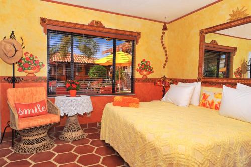 a bedroom with two beds and a chair and a window at Blue Seas Courtyard in Fort Lauderdale