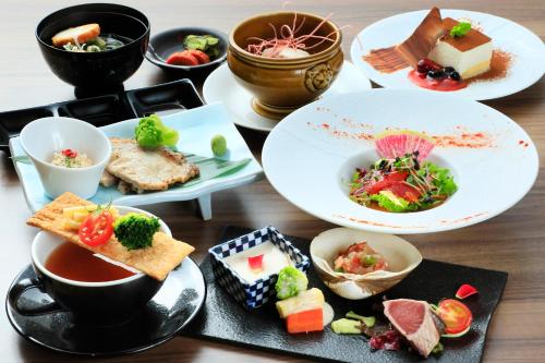 a table with plates of food and bowls of food at Naruko Fuga in Osaki