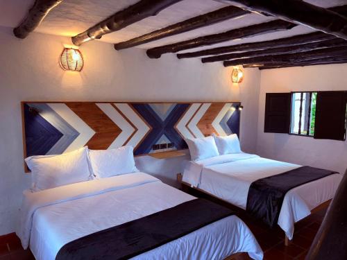 Cama o camas de una habitación en Hotel Hacienda Anacaona - San Agustín
