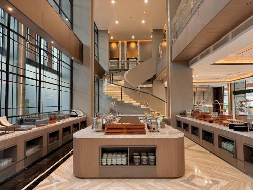a restaurant with a counter in the middle of a building at FortunaSuites Malioboro Yogyakarta in Sentool
