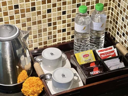 a kitchen counter with two bottles of water and food at Argya Santi Resort in Jimbaran