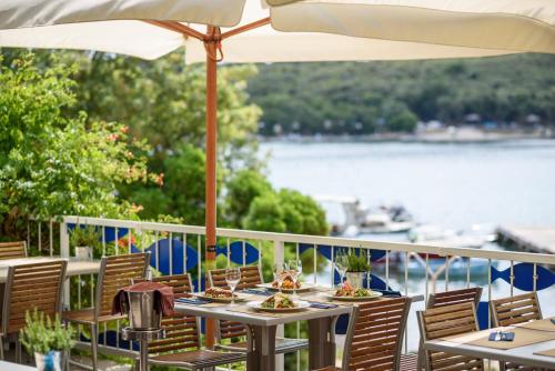 a table with plates of food and an umbrella at Maistra Camping Veštar Mobile homes in Rovinj