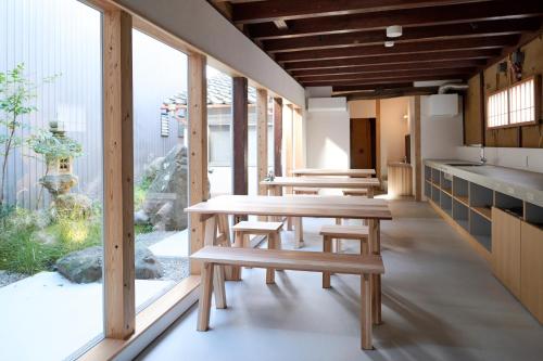 a row of wooden tables and benches in a room at metate in Kamiichi