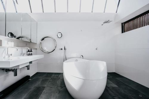 a white bathroom with a sink and a toilet at Alkina Lodge Yulu in Wattle Hill