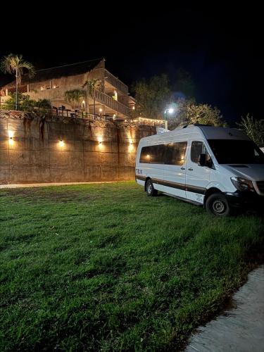 a white van parked in a field at night at Monte Ixk'al in Xilitla