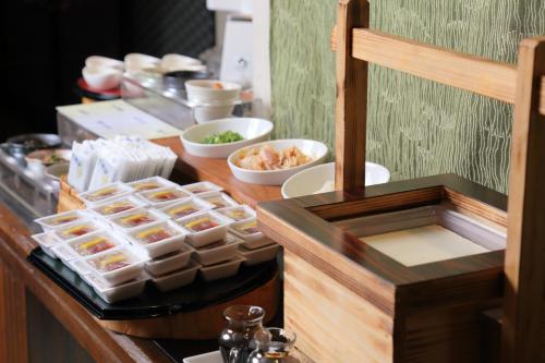 a buffet with food in plastic containers on a table at Osaka Tokyu REI Hotel in Osaka