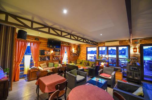 a living room filled with lots of furniture and windows at San Art Floating Hostel & Apartments in Belgrade