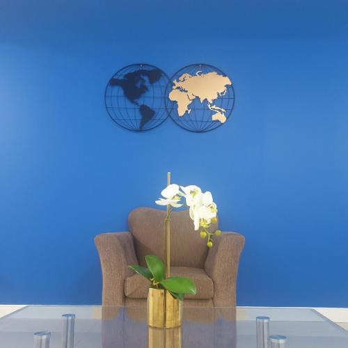 a living room with a chair and two globe clocks at HARLOE'S SUITe in Kingston