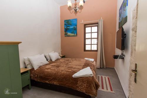 a bedroom with a bed and a window at Mark House in Nazareth