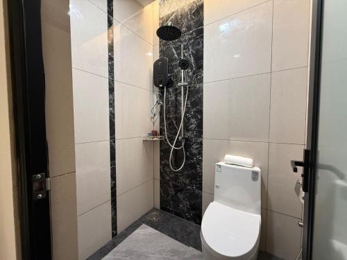 a bathroom with a toilet and a shower at OYO 91193 Hi Inn Sibu Jaya in Sibu
