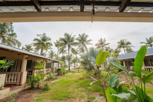 a view from the outside of a house with palm trees at C Roque Beach Resort in Colva