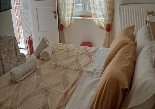 a bed with two pillows on top of it at Elias Home in Volos