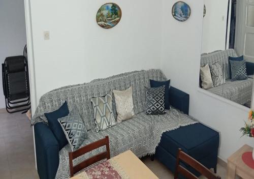 a living room with a gray couch with pillows at Elias Home in Volos