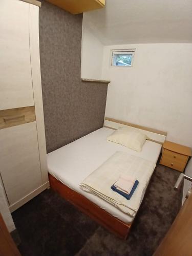 a small bedroom with a bed with a book on it at Apartment mit Gartenblick in Weiden