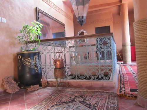 a room with a wrought iron fence and a rug at Riad Dar Barbara in Ouarzazate