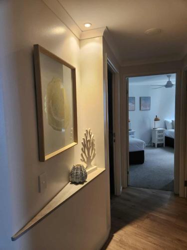 a room with a picture on the wall and a bedroom at Whalewatch Ocean Beach Resort in Point Lookout