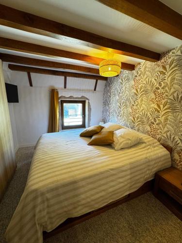 a bedroom with a large bed in a room at Au pré des pierres in Sancé