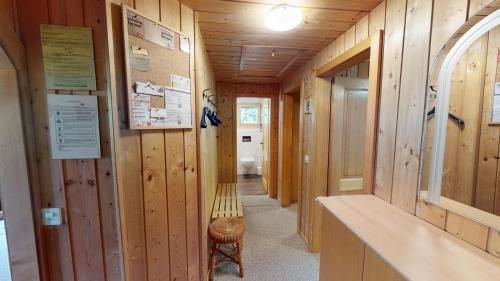 a hallway with wooden walls and a bench in a room at Nicole in Blatten bei Naters