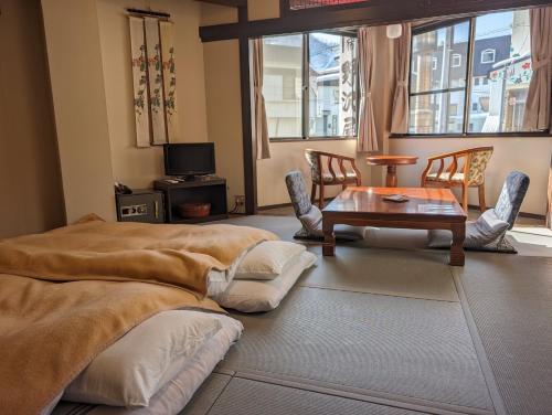 a living room with a coffee table and chairs at Oyado Nozawaya in Nozawa Onsen