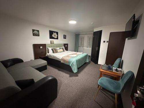 a hotel room with a bed and a couch at Vila Orizont Straja in Straja