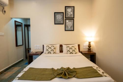 a bedroom with a white bed with a bow on it at C Roque Beach Resort in Colva