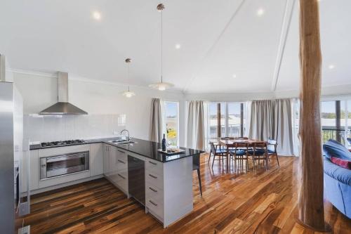 a kitchen and living room with a table and chairs at Peppy Harmony House - Coastal Calm on Geographe Bay in Capel