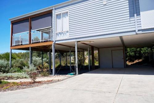 a house with a balcony on the side of it at Peppy Harmony House - Coastal Calm on Geographe Bay in Capel