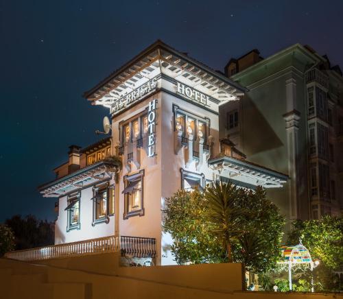 a large building with lights on it at night at Hotel Boutique Las Brisas in Santander
