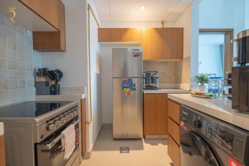 a kitchen with a stainless steel refrigerator at Al Reem Island Pearl 1BR Retreat in Abu Dhabi