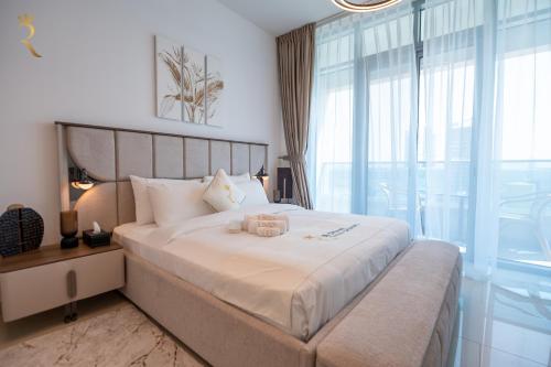 a bedroom with a bed with a teddy bear on it at Al Reem Island Pearl 1BR Retreat in Abu Dhabi
