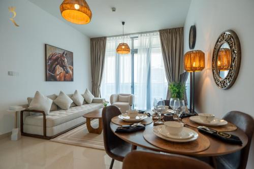 a living room with a table and a couch at Stylish Pearl 1BR - Chic Julphar Getaway in Abu Dhabi