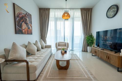 a living room with a couch and a table at Stylish Pearl 1BR - Chic Julphar Getaway in Abu Dhabi