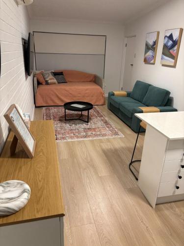 a living room with a bed and a couch at Cosy Perth retreat in Perth