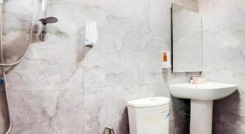 a bathroom with a toilet and a sink and a shower at 5 Diamond in Bangkok