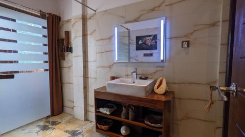 a bathroom with a sink and a mirror at Lagoon gate Tangalle Resort in Tangalle
