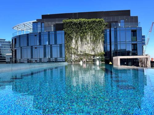 a large swimming pool in front of a building at Grand Bayview Corporate Residency in Melbourne