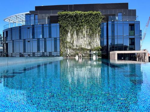 a large swimming pool in front of a building at Grand Bayview Corporate Residency in Melbourne